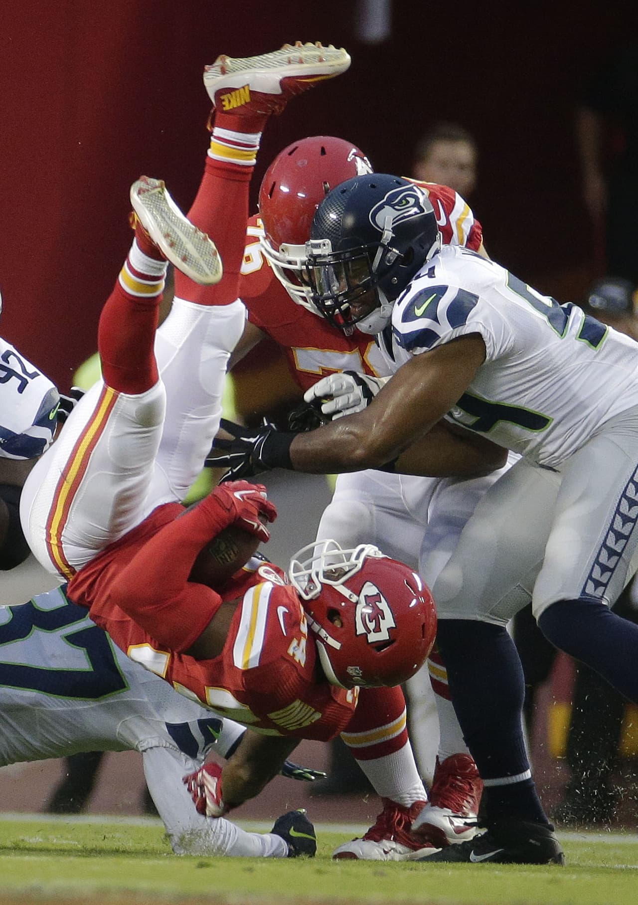 #9. DE SENTÓN: El corredor de los Kansas City Chiefs, Knile Davis (34), es tackleado por el safety libre de los Seattle Seahawks, Dion Bailey (37) y el linebacker Bobby Wagner (54) en el Arrowhead Stadium