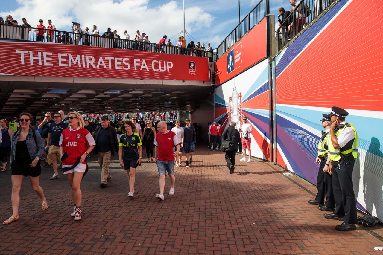 LONDON, ENGLAND - MAY 27: Police officers look on as football fans make their way to Wembley Stadium ahead of the FA Cup final on May 27, 2017 in London, England. Football fans will watch Arsenal play Chelsea in today's FA Cup final amid tightened security following the May 22nd Manchester Arena terror attack. (Photo by Jack Taylor/Getty Images)