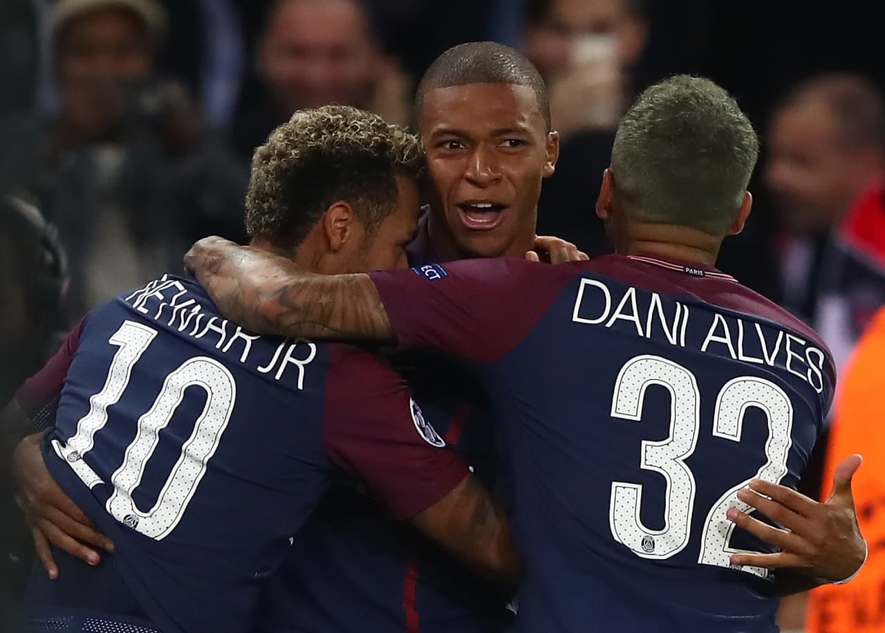 PARIS, FRANCE - SEPTEMBER 27: Neymar of PSG (L) celebrates with Kylian Mbappe of PSG and Dani Alves of PSG after scoring his sides third goal during the UEFA Champions League group B match between Paris Saint-Germain and Bayern Muenchen at Parc des Princes on September 27, 2017 in Paris, France. (Photo by Alexander Hassenstein/Bongarts/Getty Images)
