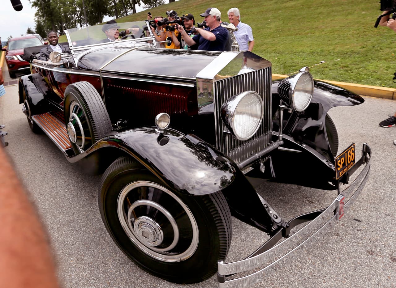 Pittsburgh Steelers wide receiver Antonio Brown, left, arrives in a chauffer driven 1931 Rolls Royce Phantom 1 for NFL football training camp in Latrobe, Pa., Thursday, July 27, 2017 . (AP Photo/Keith Srakocic)