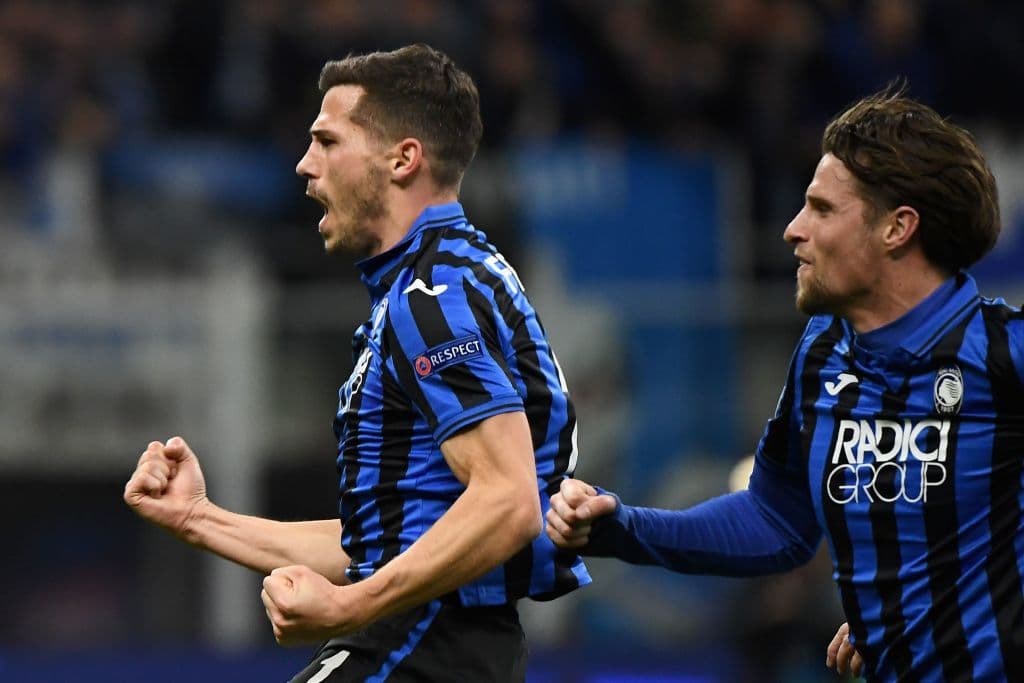 Atalanta's Swiss midfielder Remo Freuler (L) celebrates with Atalanta's Dutch defender Hans Hateboer after scoring during the UEFA Champions League round of 16 first leg football match Atalanta Bergamo vs Valencia on February 19, 2020 at the San Siro stadium in Milan. (Photo by Vincenzo PINTO / AFP) (Photo by VINCENZO PINTO/AFP via Getty Images)