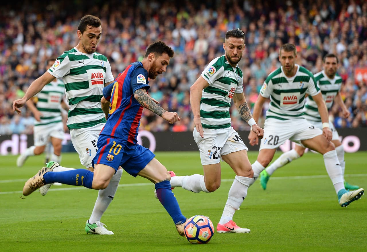 Barcelona's Argentinian forward Lionel Messi (2L) vies with Eibar's Argentinian midfielder Gonzalo Escalante and Eibar's defender David Junca (R) during the Spanish league football match FC Barcelona vs SD Eibar at the Camp Nou stadium in Barcelona on May 21, 2017. / AFP PHOTO / Josep LAGO (Photo credit should read JOSEP LAGO/AFP/Getty Images)
