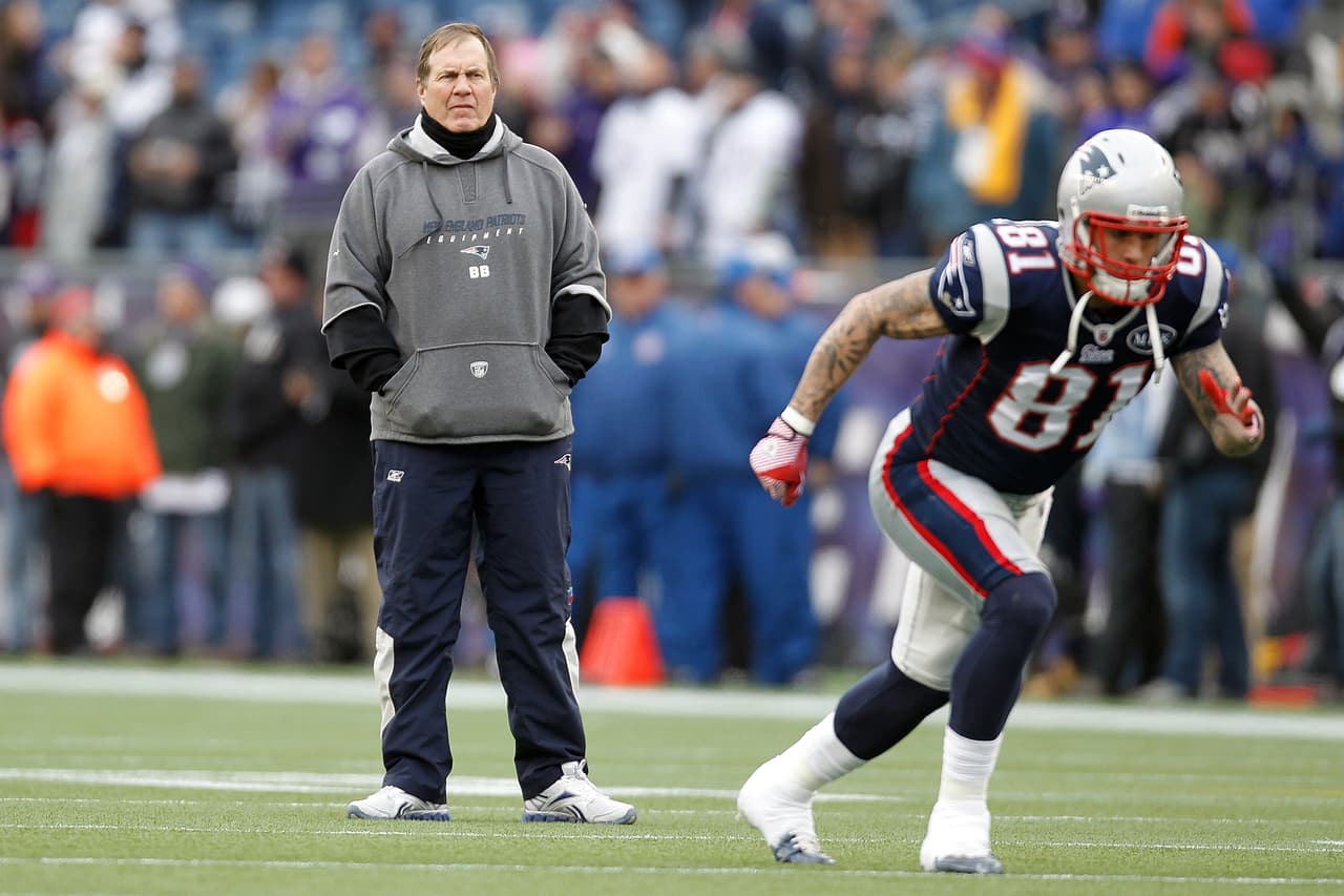 New England Patriots head coach Bill Belichick watches as tight end Aaron Hernandez (81) warms up before the AFC Championship NFL football game against the Baltimore Ravens Sunday, Jan. 22, 2012, in Foxborough, Mass. (AP Photo/Winslow Townson)