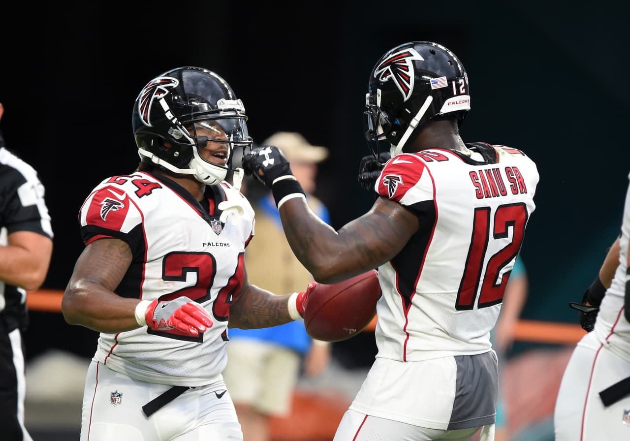 Atlanta Falcons running back Devonta Freeman (24( celebrates with wide receiver Mohamed Sanu (12) after a touchdown catch during a Thursday, Aug. 10, 2017, week 1 NFL pre-season football game in Miami Gardens, Fla. The Miami Dolphins defeated the Falcons 23 - 20. (Al Messerschmidt via AP)