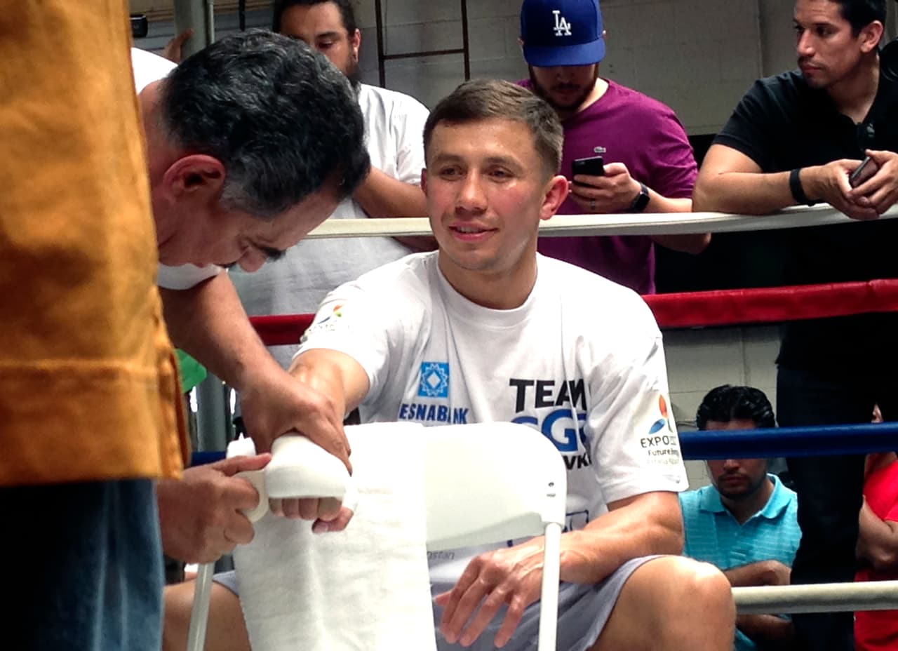 In this photo taken Wednesday, April 20, 2016, Gennady Golovkin has his hands wrapped by trainer Abel Sanchez prior to a workout for his middleweight title defense at the Wild Card West Boxing Club in Santa Monica, Calif. Golovkin will go for his 22nd consecutive knockout victory when he defends his 160-pound belts in a bout with unbeaten Dominic Wade at the Forum in Inglewood, Calif., on Saturday, April 23. (AP Photo/Greg Beacham)