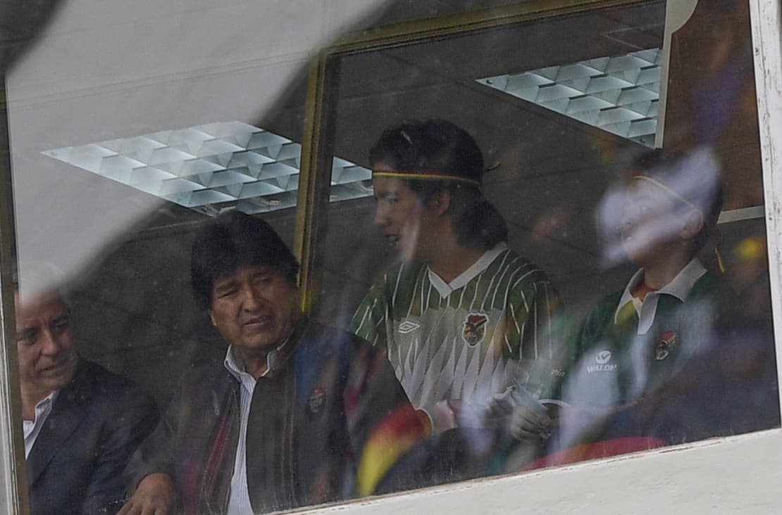 Bolivian President Evo Morales (2nd-L) and Vice President Alvaro Garcia Linera (L) watch the 2018 FIFA World Cup qualifier football match against Argentina in La Paz, on March 28, 2017. / AFP PHOTO / JUAN MABROMATA (Photo credit should read JUAN MABROMATA/AFP/Getty Images)