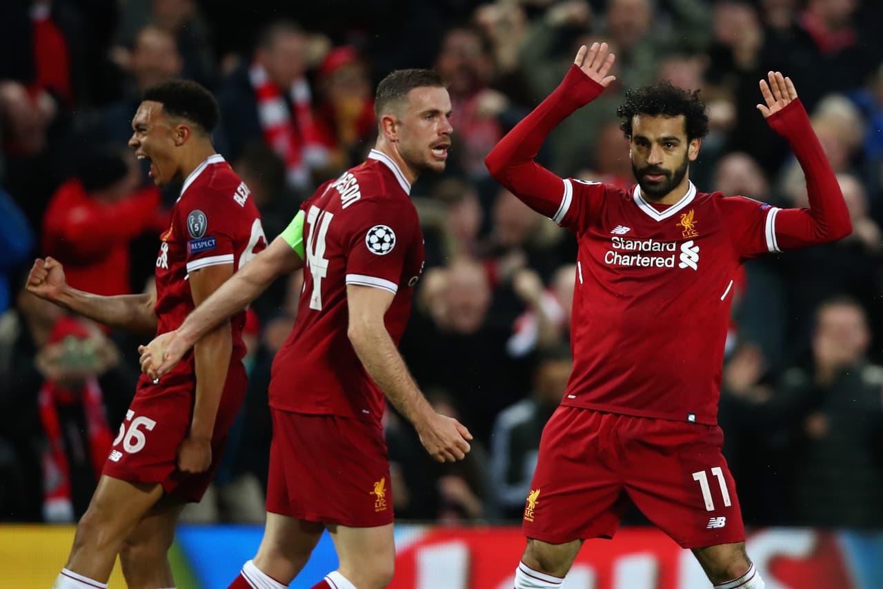 LIVERPOOL, ENGLAND - APRIL 24: Mohamed Salah of Liverpool (11) celebrates after scoring his sides first goal with team mates Jordan Henderson and Trent Alex Arnold of Liverpool during the UEFA Champions League Semi Final First Leg match between Liverpool and A.S. Roma at Anfield on April 24, 2018 in Liverpool, United Kingdom. (Photo by Clive Brunskill/Getty Images)