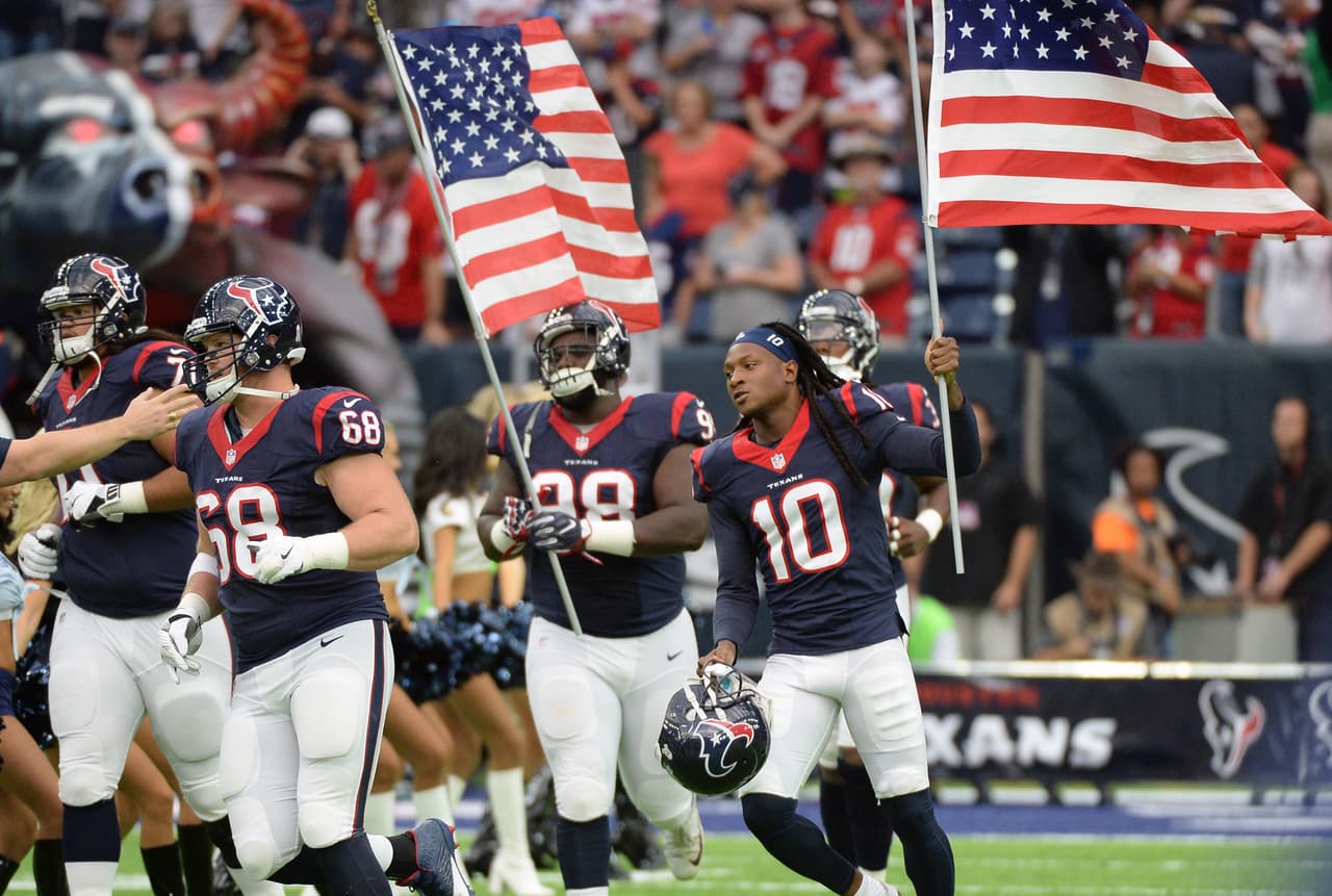 Houston Texans' DeAndre Hopkins (10) ad teammates carry flags on to the field as they help celebrate Salute to Service day before an NFL football game against the Detroit Lions, Sunday, October, 30, 2016, in Houston. (AP Photo/George Bridges)