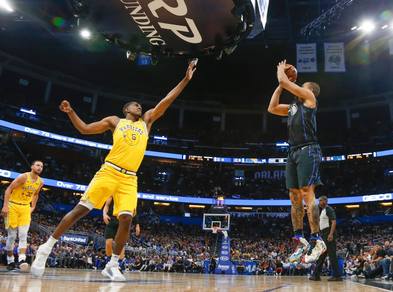 Kevon Looney de los Warriors intenta bloquear el tiro del guardia Isaiah Briscoe. El triunfo es para los de Orlando 100-96.