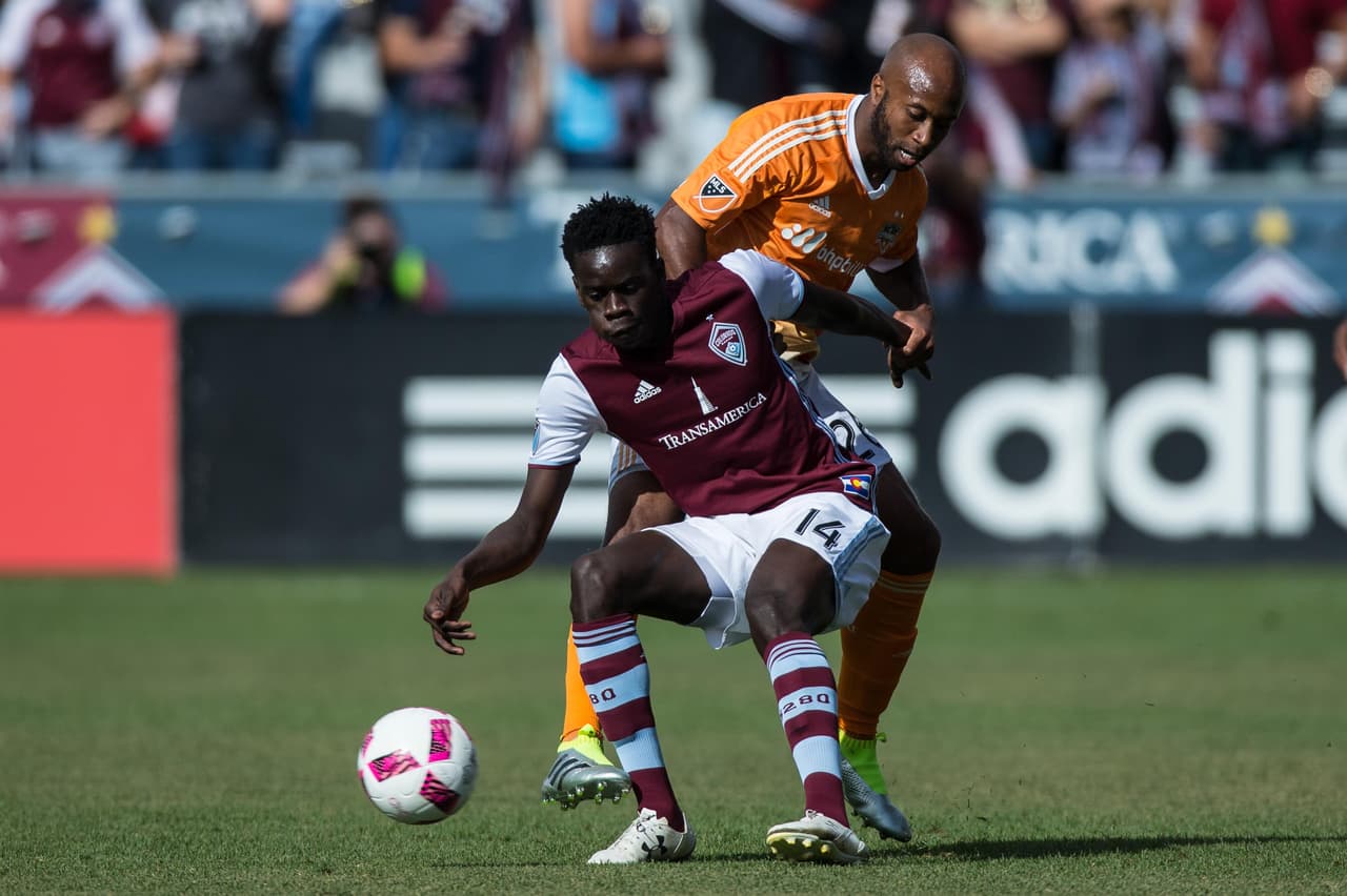 Oct 23, 2016; Commerce City, CO, USA; Colorado Rapids forward Dominique Badji (14) and Houston Dynamo midfielder Collen Warner (26) battle for the ball in the first half at Dick's Sporting Goods Park. Mandatory Credit: Isaiah J. Downing-USA TODAY Sports