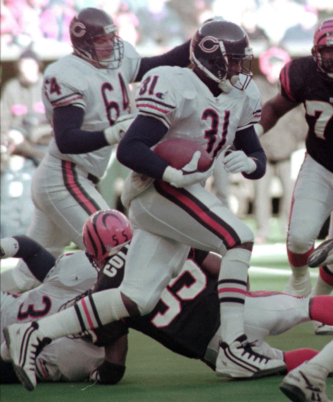 FILE - In this Dec. 10, 1995, file photo, Chicago Bears running back Rashaan Salaam breaks through the line against the Cincinnati Bengals during an NFL game in Cincinnati. Salaam had a terrific rookie season with the Chicago Bears in 1995, rushing for 1,074 yards and 10 touchdowns. Authorities say 1994 Heisman winner Rashaan Salaam has been found dead in a park in Boulder. The Boulder County coroner’s office said Tuesday, Dec. 6, 2016, that it is still investigating the death of 42-year-old Salaam. (AP Photo/Mark Lyons)
