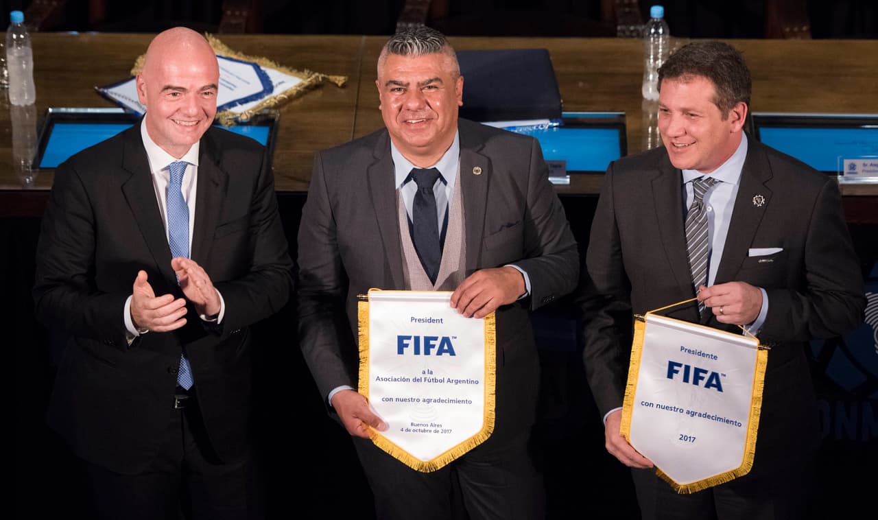 BUENOS AIRES, ARGENTINA - OCTOBER 04: (FROM L TO R) Gianni Infantino president of FIFA, Claudio Chiqui Tapia president of AFA and Alejandro Dominguez of CONMEBOL pose after a press conference at AFA as part of the official visit of President of FIFA Gianni Infantino to Buenos Aires to discuss Argentina, Uruguay and Paraguay joint candidacy for the FIFA 2030 World Cup on October 04, 2017 in Buenos Aires, Argentina. (Photo by Rodrigo Valle/Getty Images)