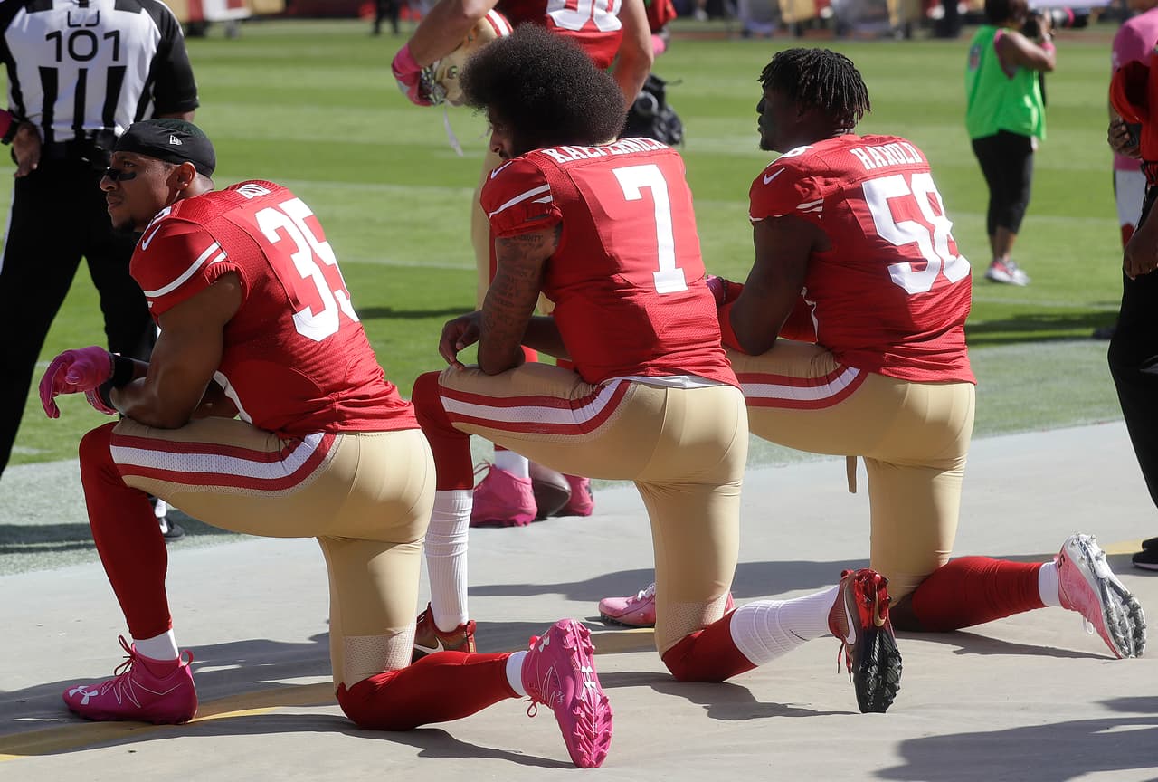 San Francisco 49ers safety Eric Reid (35), quarterback Colin Kaepernick (7) and outside linebacker Eli Harold (58) kneel during the national anthem before an NFL football game against the Tampa Bay Buccaneers in Santa Clara, Calif., Sunday, Oct. 23, 2016. (AP Photo/Marcio Jose Sanchez)