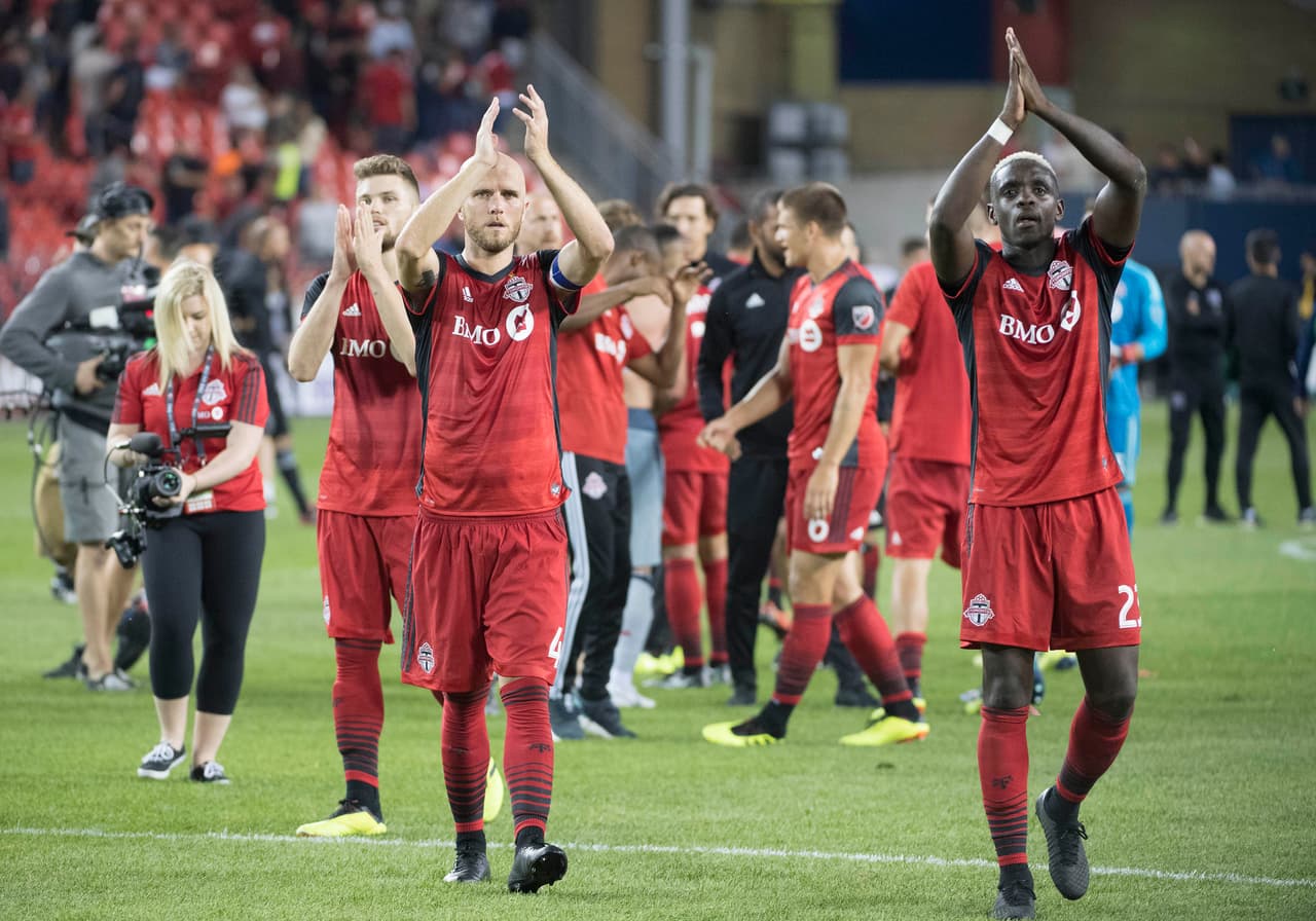 Jul 28, 2018; Toronto, Ontario, CAN; Toronto FC midfielder Michael Bradley (4) and defender Chris Mavinga (23) acknowledge the crowd after the game against the Chicago Fire at BMO Field. Mandatory Credit: Nick Turchiaro-USA TODAY Sports