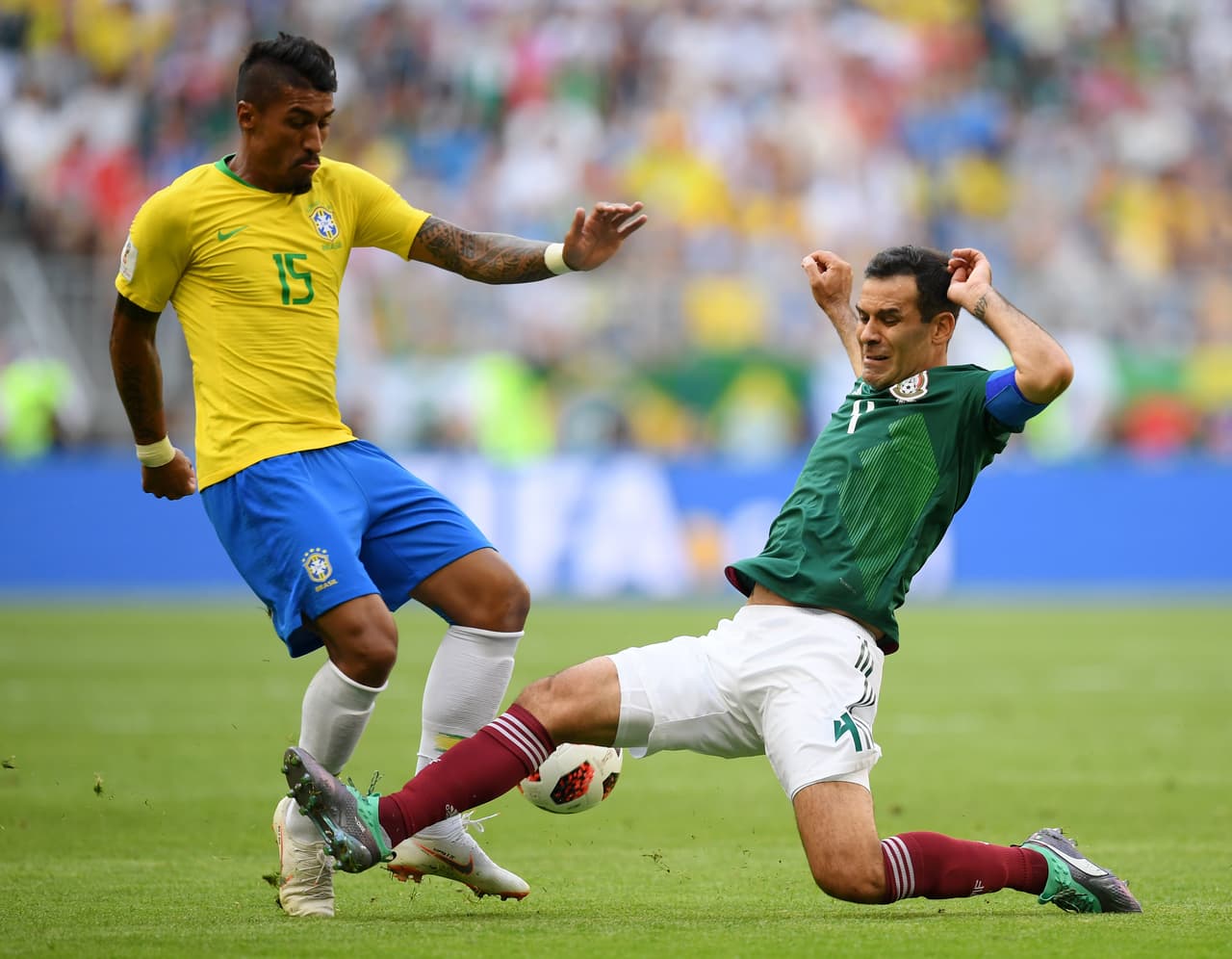 SAMARA, RUSSIA - JULY 02: Rafael Marquez of Mexico tackles Paulinho of Brazil during the 2018 FIFA World Cup Russia Round of 16 match between Brazil and Mexico at Samara Arena on July 2, 2018 in Samara, Russia. (Photo by Matthias Hangst/Getty Images)