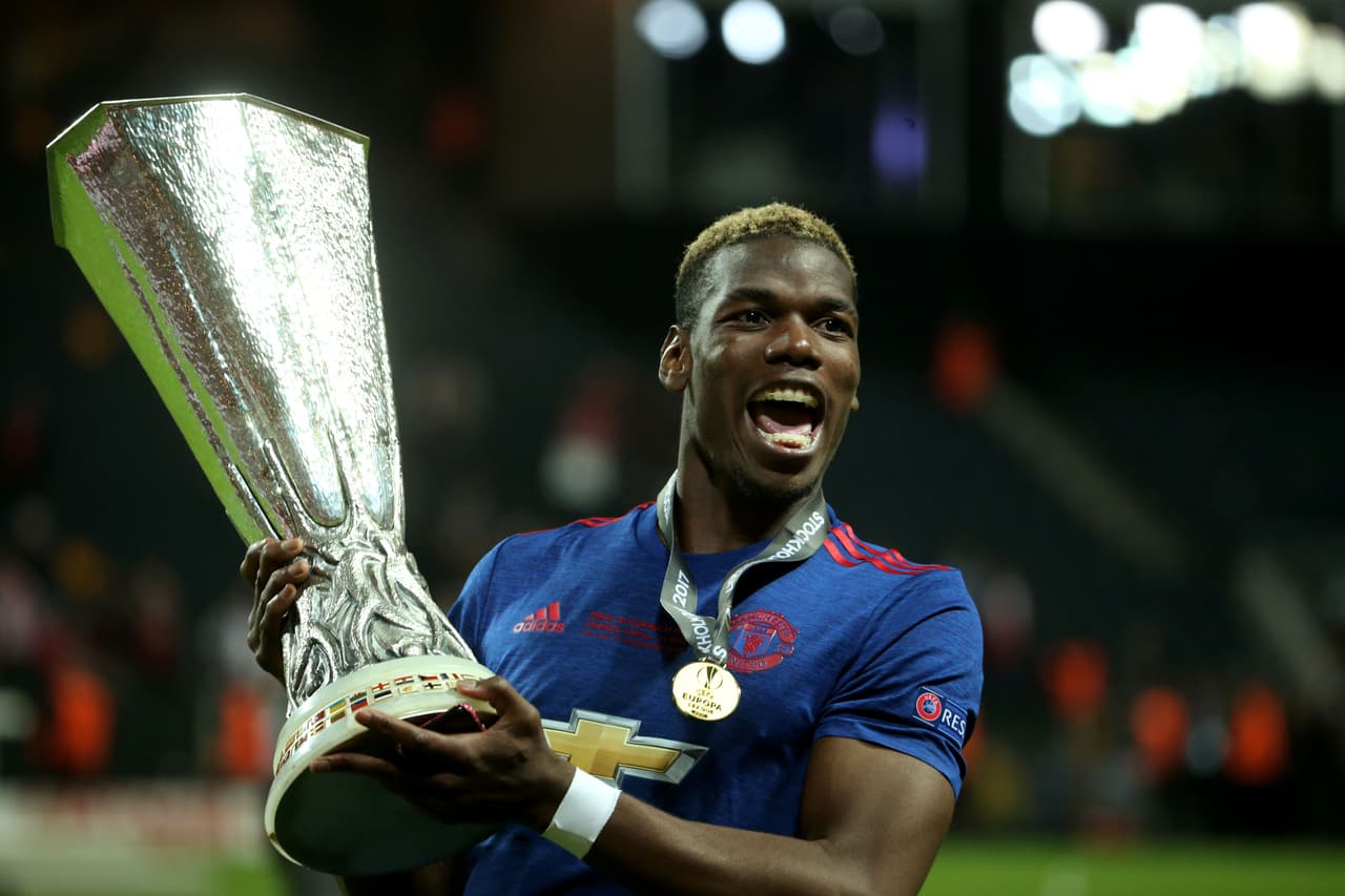 Manchester United's French midfielder Paul Pogba celebrates with the trophy after his team won the UEFA Europa League final football match Ajax Amsterdam v Manchester United on May 24, 2017 at the Friends Arena in Solna outside Stockholm. / AFP PHOTO / Soren Andersson (Photo credit should read SOREN ANDERSSON/AFP/Getty Images)
