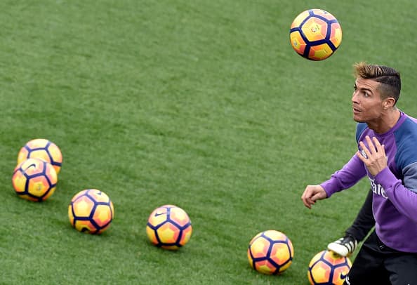 Real Madrid's Portuguese forward Cristiano Ronaldo heads a ball during a training session at Valdebebas training ground in Madrid on December 9, 2016, on the eve of the Spanish League match Real Madrid CF vs RC Deportivo de La Coruña. / AFP / GERARD JULIEN (Photo credit should read GERARD JULIEN/AFP/Getty Images)