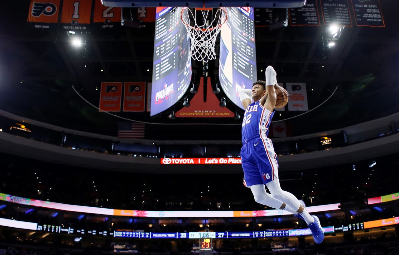 Philadelphia 76ers' Matisse Thybulle (22) goes up for a dunk during the first half of an NBA basketball game against the Detroit Pistons, Wednesday, March 11, 2020, in Philadelphia. (AP Photo/Matt Slocum)