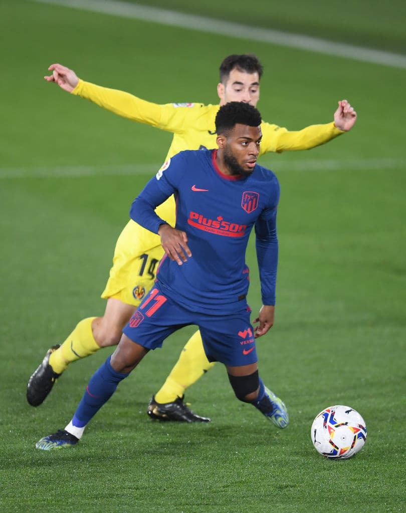 VILLAREAL, SPAIN - FEBRUARY 28: Thomas Lemar of Atletico de Madrid is challenged by Manu Trigueros of Villarreal CF during the La Liga Santander match between Villarreal CF and Atletico de Madrid at Estadio de la Ceramica on February 28, 2021 in Villareal, Spain. Sporting stadiums around Spain remain under strict restrictions due to the Coronavirus Pandemic as Government social distancing laws prohibit fans inside venues resulting in games being played behind closed doors. (Photo by Alex Caparros/Getty Images)