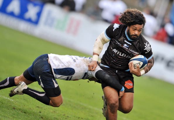 Agen's Tongan lock Lisiate Faaoso (R) is tackled by Bayonne's number eigth Sione Lauaki (L) during the French Top 14 rugby union match Agen vs Bayonne on December 4, 2011 in Agen .AFP PHOTO PIERRE ANDRIEU (Photo credit should read PIERRE ANDRIEU/AFP/Getty Images)