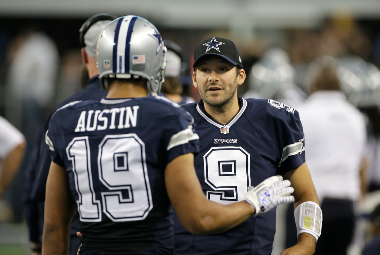 Dallas Cowboys wide receiver Miles Austin (19) and quarterback Tony Romo (9) talk in the bench area during the first half of an NFL football game against the Oakland Raiders Thursday, Nov. 28, 2013, in Arlington, Texas. (AP Photo/Tim Sharp)