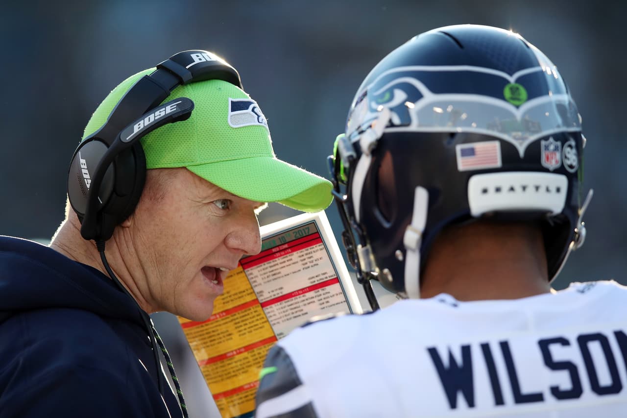 Seattle Seahawks offensive coordinator Darrell Bevell talks to Seattle Seahawks quarterback Russell Wilson (3) on the sideline during the 2017 NFL week 14 regular season football game against the Jacksonville Jaguars, Sunday, Dec. 10, 2017 in Jacksonville, Fla. The Jaguars won the game 30-24. (Paul Spinelli via AP)