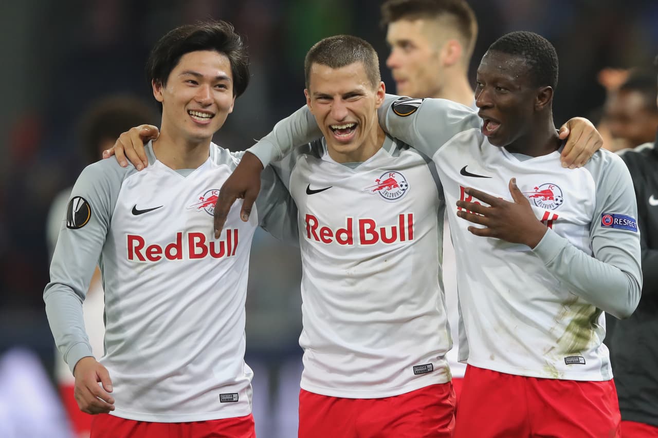 SALZBURG, AUSTRIA - APRIL 12: Stefan Lainer (C) of Salzburg celebrates victory with his team mates Takumi Minamino (L) and Amadou Haidara (R) after winning the UEFA Europa League quarter final leg two match between RB Salzburg and Lazio Roma at Stadion Salzuburg on April 12, 2018 in Salzburg, Austria. (Photo by Alexander Hassenstein/Bongarts/Getty Images)