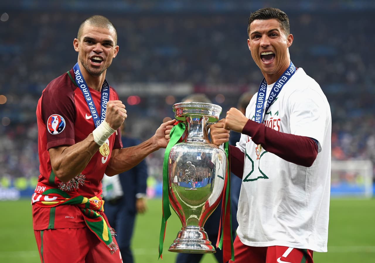 PARIS, FRANCE - JULY 10: Cristiano Ronaldo (R) and Pepe (L) of Portugal pose for photographs holding the Henri Delaunay trophy to celebrate after their 1-0 win against France in the UEFA EURO 2016 Final match between Portugal and France at Stade de France on July 10, 2016 in Paris, France. (Photo by Laurence Griffiths/Getty Images)