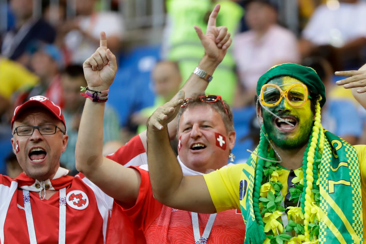 Fans cheer for their teams prior to the group E match between Brazil and Switzerland at the 2018 soccer World Cup in the Rostov Arena in Rostov-on-Don, Russia, Sunday, June 17, 2018. (AP Photo/Andre Penner)
