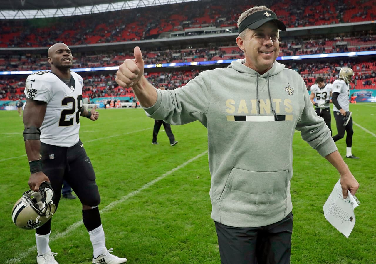 FILE - In this Sunday Oct. 1, 2017, file photo, New Orleans Saints head coach Sean Payton and running back Adrian Peterson gesture as they leaves the field after an NFL football game against the Miami Dolphins at Wembley Stadium in London. In the Saints’ first four games this year, they went from double-digit losses the first two weeks, to wins by 20 or more the next two. (AP Photo/Matt Dunham, File)