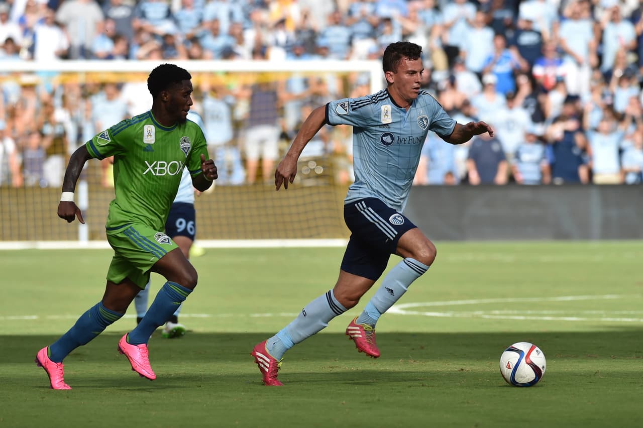 Sep 27, 2015; Kansas City, KS, USA; Sporting KC forward Bernardo Anor (11) dribbles the ball against Seattle Sounders FC defender Oniel Fisher (91) during the first half at Sporting Park. Mandatory Credit: Peter G. Aiken-USA TODAY Sports