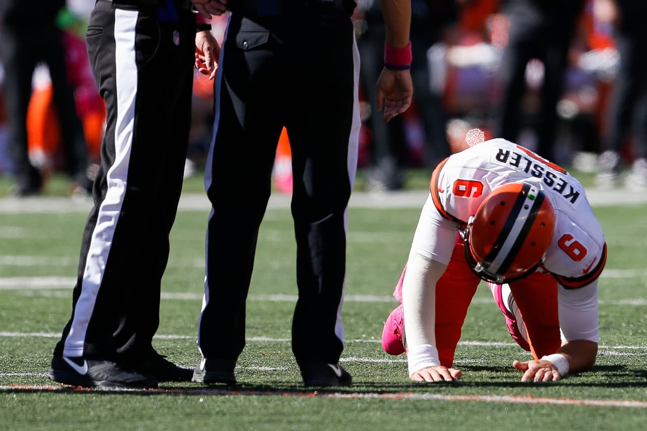 Cleveland Browns quarterback Cody Kessler (6) struggles to his feet after taking a hit before being taken into the locker room for a concussion protocol in the first half of an NFL football game against the Cincinnati Bengals, Sunday, Oct. 23, 2016, in Cincinnati. (AP Photo/Gary Landers)