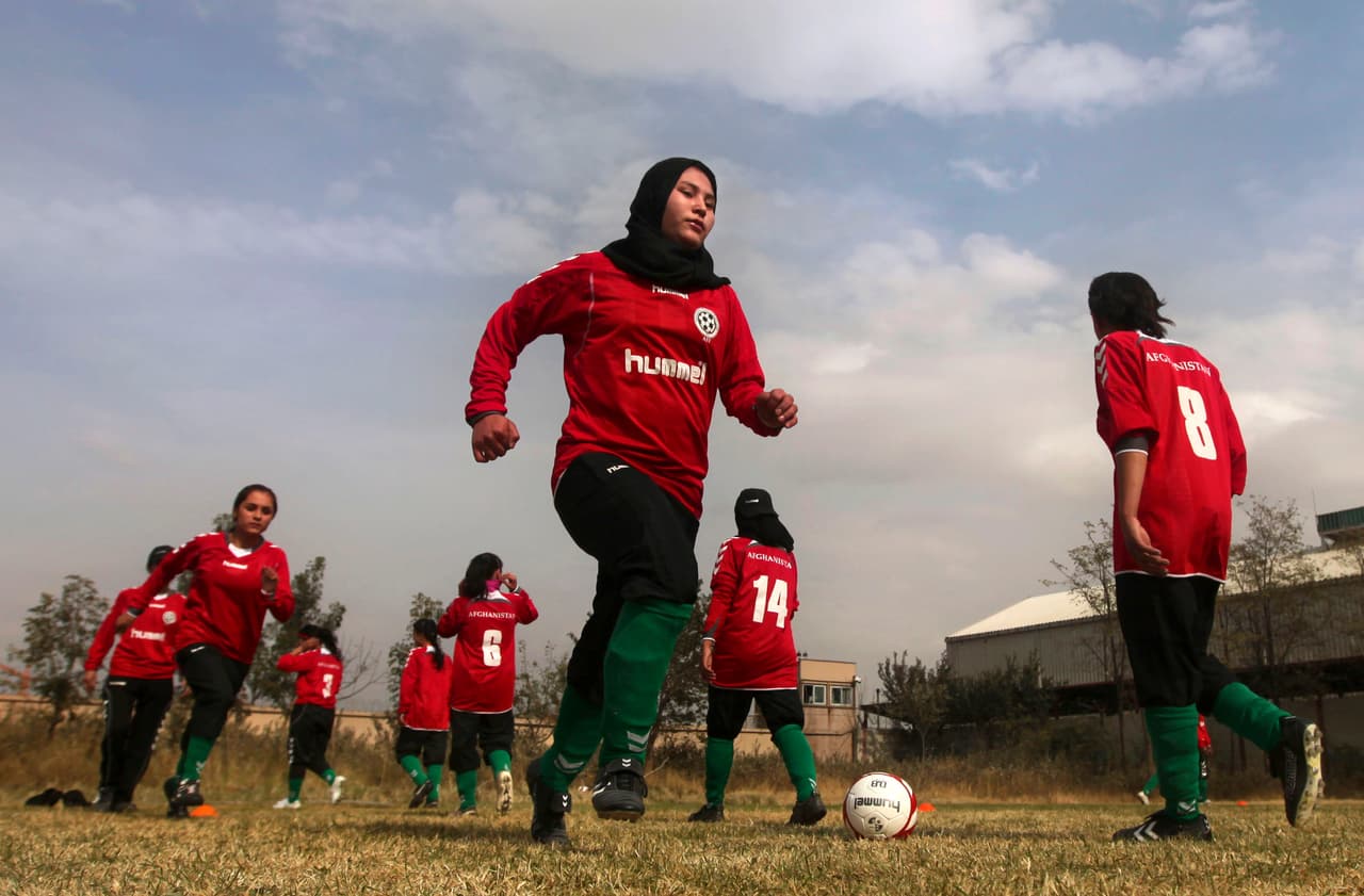Members of the Afghan women's national football team warm-up before a friendly match against the ISAF (International Security Assistance Force) female soccer team at the ISAF headquarters in Kabul, Afghanistan, Friday, Oct. 29, 2010. The Afghan team scored the only goal of the match in the first half of the game and held on to maintain their lead to win the game 1-0. (AP Photo/Altaf Qadri)