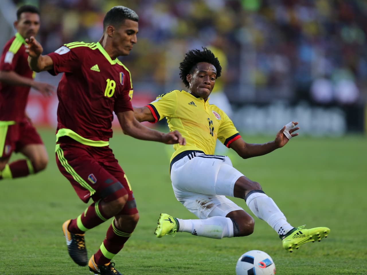 Venezuela's Victor Garcia, left, and Colombia's James Rodriguez battle for the ball during a 2018 Russia World Cup qualifying soccer match in San Cristobal, Venezuela, Thursday, Aug. 31, 2017. (AP Photo/Fernando Llano)