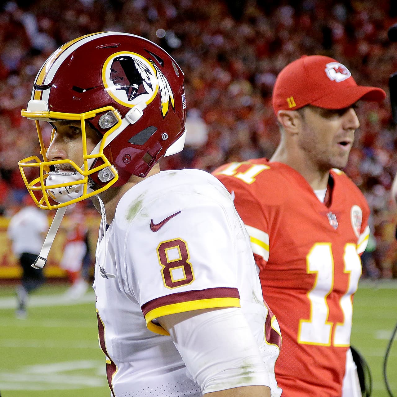 Kansas City Chiefs quarterback Alex Smith (11) and Washington Redskins quarterback Kirk Cousins (8) walk off the field after an NFL football game Monday, Oct. 2, 2017, in Kansas City, Mo. The Chiefs won 29-20. (AP Photo/Charlie Riedel)