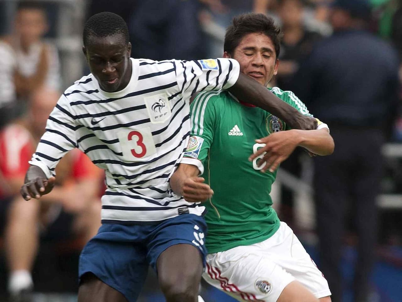 Benjamin Mendy pelea un balón con Julio Gómez en los Cuartos de Final de México 2011.