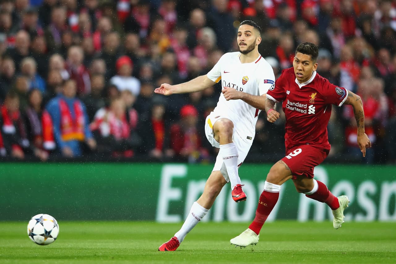 LIVERPOOL, ENGLAND - APRIL 24: Kostas Manolas of AS Roma clears from Roberto Firmino of Liverpool during the UEFA Champions League Semi Final First Leg match between Liverpool and A.S. Roma at Anfield on April 24, 2018 in Liverpool, United Kingdom. (Photo by Clive Brunskill/Getty Images)