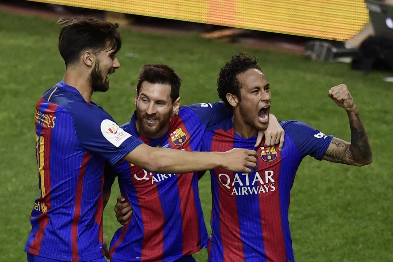 Barcelona's Argentinian forward Lionel Messi (C) celebrates with Barcelona's Brazilian forward Neymar (R) and Barcelona's Portuguese midfielder Andre Gomes after scoring the opnener during the Spanish Copa del Rey (King's Cup) final football match FC Barcelona vs Deportivo Alaves at the Vicente Calderon stadium in Madrid on May 27, 2017. / AFP PHOTO / JAVIER SORIANO (Photo credit should read JAVIER SORIANO/AFP/Getty Images)
