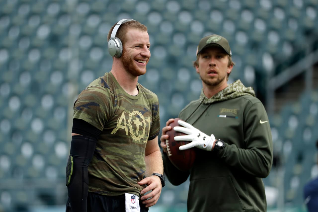 Philadelphia Eagles' Carson Wentz, left, and Nick Foles warm up before an NFL football game against the Denver Broncos, Sunday, Nov. 5, 2017, in Philadelphia. (AP Photo/Michael Perez)