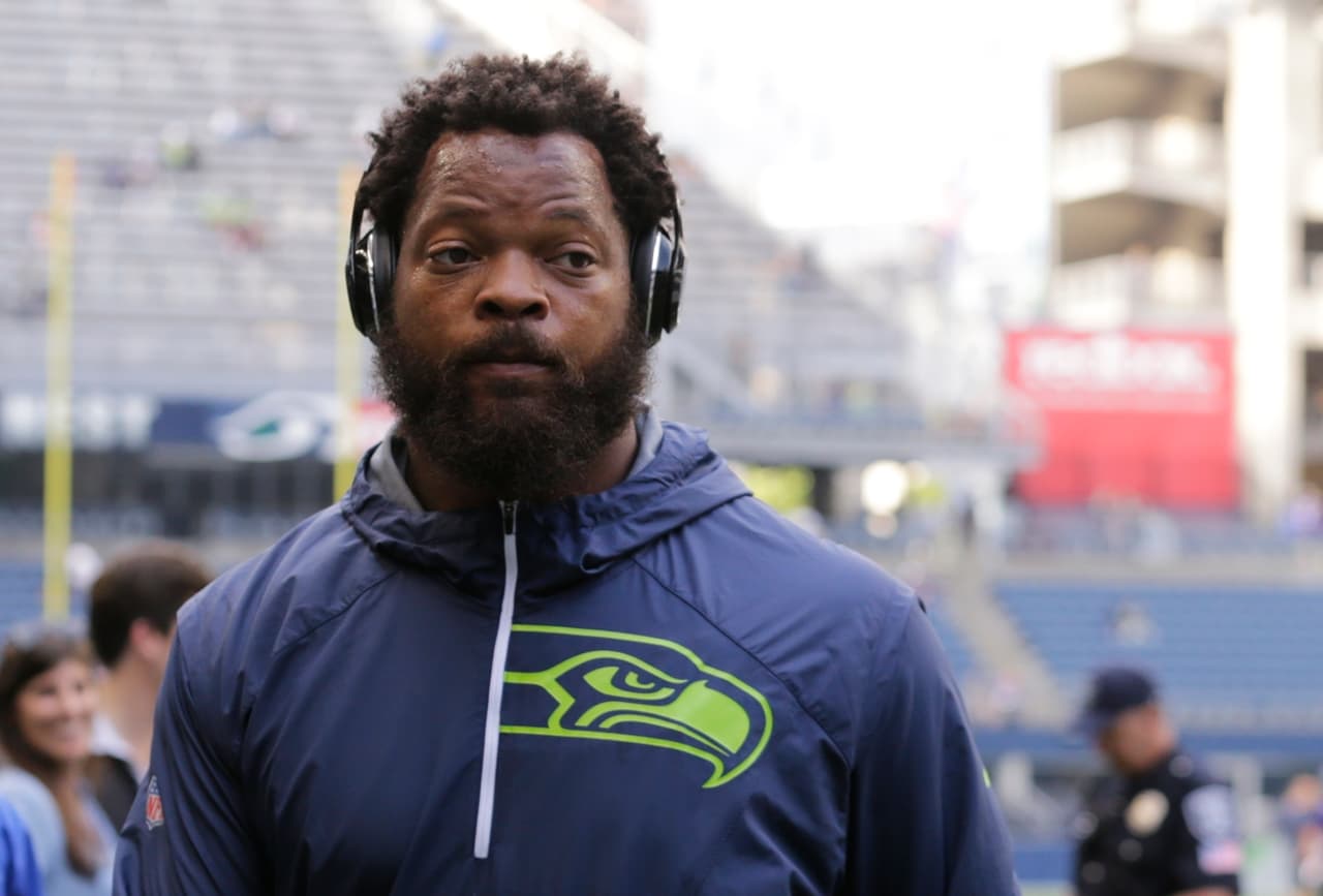 Seattle Seahawks defensive end Michael Bennett walks on the field during warmups before an NFL preseason football game against the Minnesota Vikings, Friday, Aug. 18, 2017, in Seattle. (AP Photo/Stephen Brashear)
