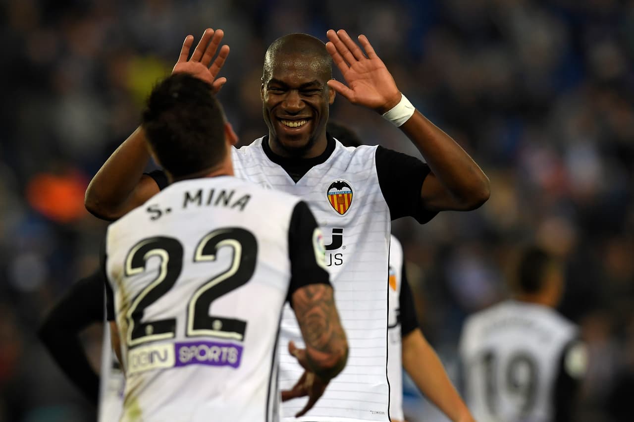 Valencia's French midfielder Geoffrey Kondogbia (R) celebrates with Valencia's Spanish forward Santiago Mina Lorenzo during the Spanish league football match RCD Espanyol vs Valencia CF at the RCDE Stadium in Cornella de Llobregat on November 19, 2017. / AFP PHOTO / LLUIS GENE (Photo credit should read LLUIS GENE/AFP/Getty Images)