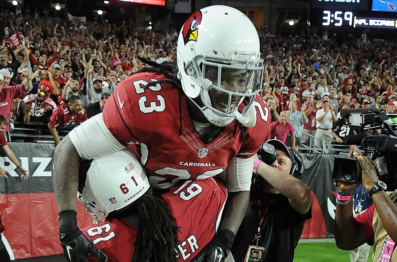 Arizona Cardinals running back (23) Chris Johnson is lifted in the air by guard (61) Jonathan Cooper after Johnson scored a touchdown in the first half of a game against the Baltimore Ravens played at University of Phoenix Stadium in Glendale, Ariz. on Monday, Oct. 26, 2015. (AP Photo/John Cordes)
