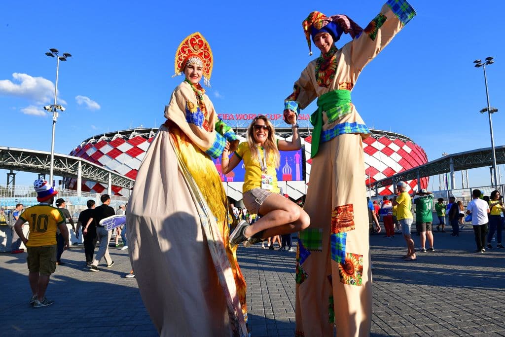 A Brazilian fan poses with performers on stilts outside the stadium before the Russia 2018 World Cup Group E football match between Serbia and Brazil at the Spartak Stadium in Moscow on June 27, 2018. (Photo by Mladen ANTONOV / AFP) (Photo credit should read MLADEN ANTONOV/AFP/Getty Images)