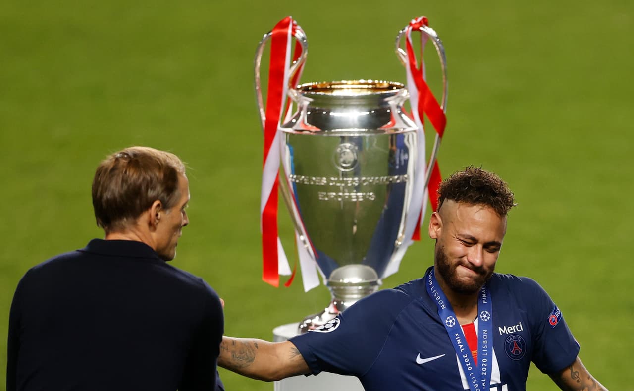 Paris Saint-Germain's German coach Thomas Tuchel (L) consoles Paris Saint-Germain's Brazilian forward Neymar (R) next to the the European Champion Clubs' Cup at the end of the UEFA Champions League final football match between Paris Saint-Germain and Bayern Munich at the Luz stadium in Lisbon on August 23, 2020. (Photo by MATTHEW CHILDS / POOL / AFP) (Photo by MATTHEW CHILDS/POOL/AFP via Getty Images)