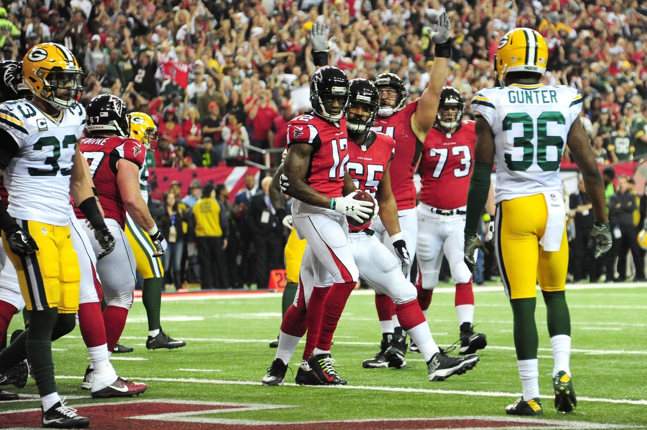 ATLANTA, GA - JANUARY 22: Mohamed Sanu #12 of the Atlanta Falcons celebrates scoring a first quarter 2-yard touchdown with Chris Chester #65 against the Green Bay Packers in the NFC Championship Game at the Georgia Dome on January 22, 2017 in Atlanta, Georgia. (Photo by Scott Cunningham/Getty Images)