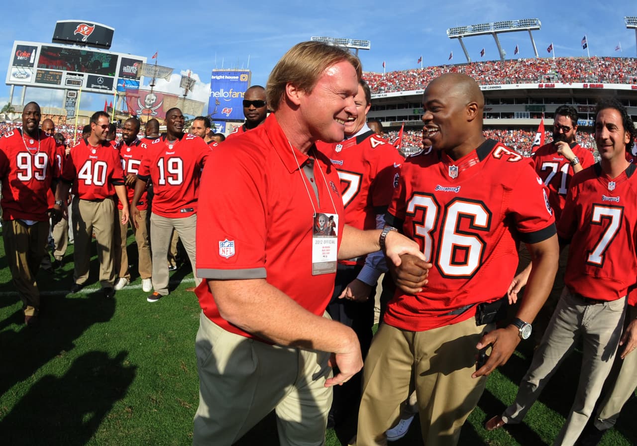 Former coach Jon Gruden of the Tampa Bay Buccaneers celebrates with former players during half-time ceremonies as the Philadelphia Eagles play Dec. 9, 2012 at Raymond James Stadium in Tampa, Fla. Tampa celebrated the 10th anniversary of its victory in Super Bowl XXXVII. (Al Messerschmidt via AP)