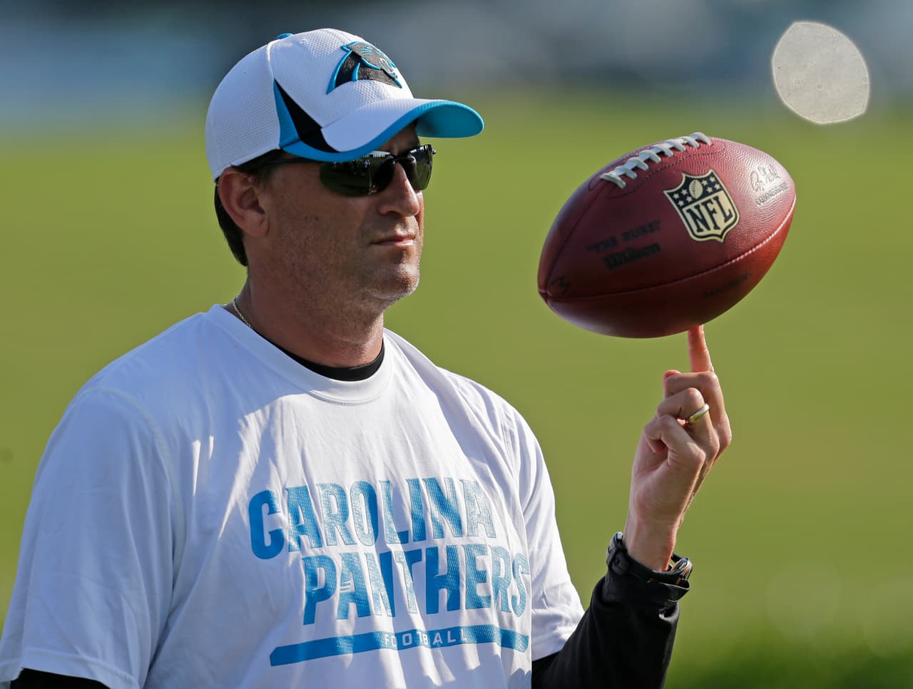 Carolina Panthers offensive coordinator Mike Shula spins a football on his finger during practice at NFL football training camp in Spartanburg, S.C., Friday, July 26, 2013. (AP Photo/Chuck Burton)