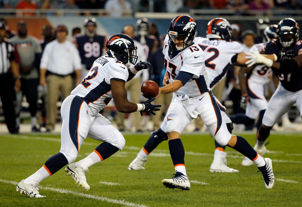 Denver Broncos quarterback Trevor Siemian (13) hands off the ball to running back C.J. Anderson (22) during the first half of an NFL preseason football game against the Chicago Bears, Thursday, Aug. 10, 2017, in Chicago. (AP Photo/Charles Rex Arbogast)