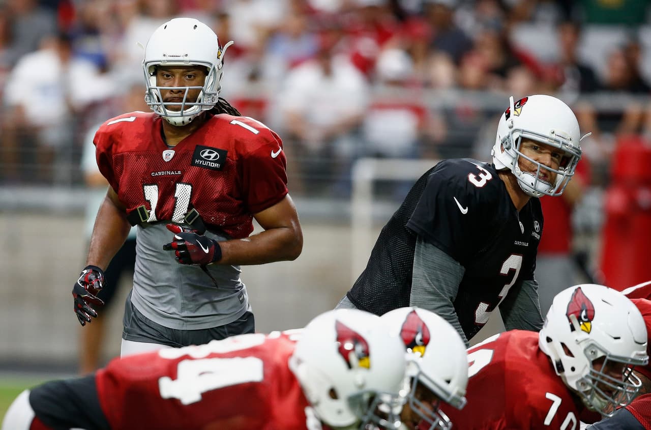 Arizona Cardinals quarterback Carson Palmer (3) gets ready for the snap of the ball as receiver Larry Fitzgerald (11) runs in motion during an NFL football training camp Monday, July 24, 2017, in Glendale, Ariz. (AP Photo/Ross D. Franklin)