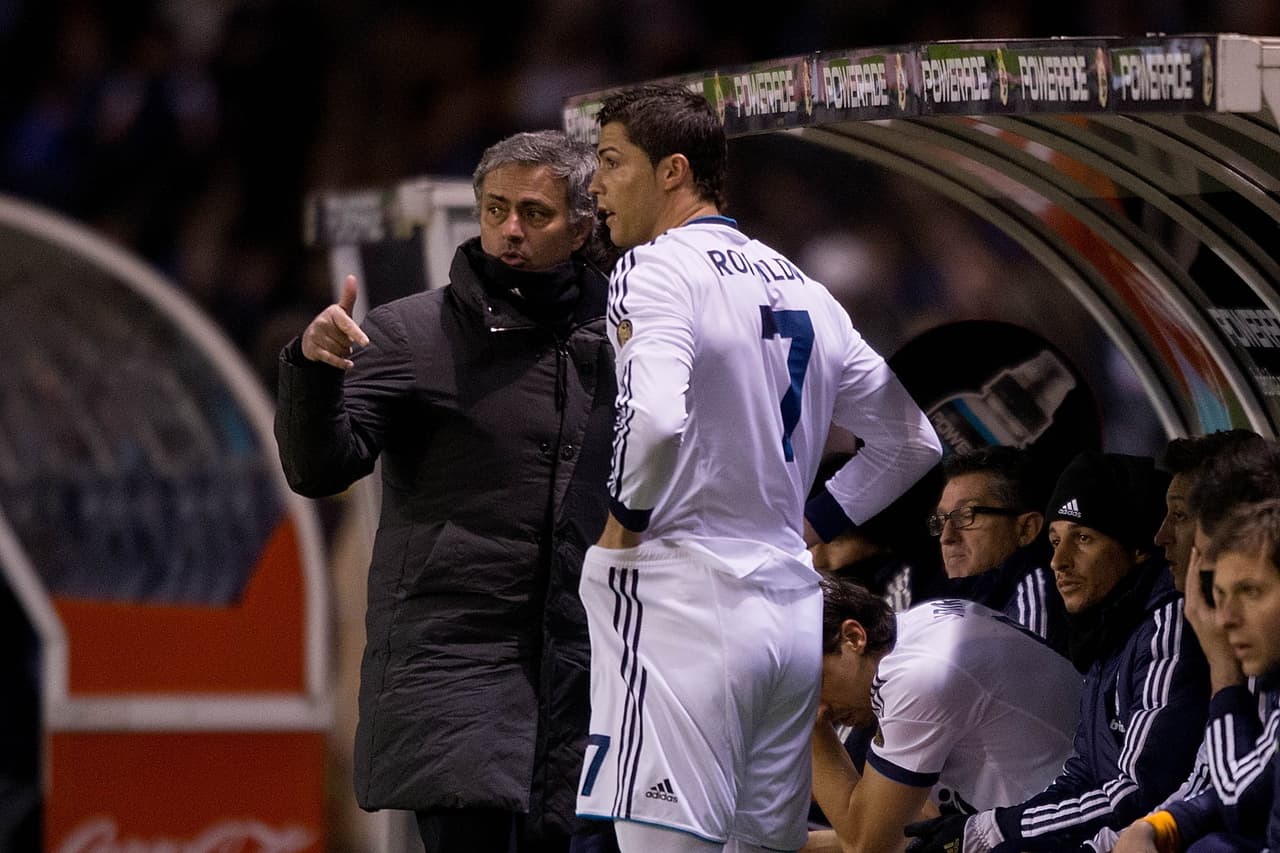 LA CORUNA, SPAIN - FEBRUARY 23: Head coach Jose Mourinho (L) of Real Madrid CF gives instructions to Cristiano Ronaldo (2ndl) on the desk during the La Liga match between RC Deportivo La Coruna and Real Madrid CF at Riazor Stadium on February 23, 2013 in La Coruna, Spain. (Photo by Gonzalo Arroyo Moreno/Getty Images)